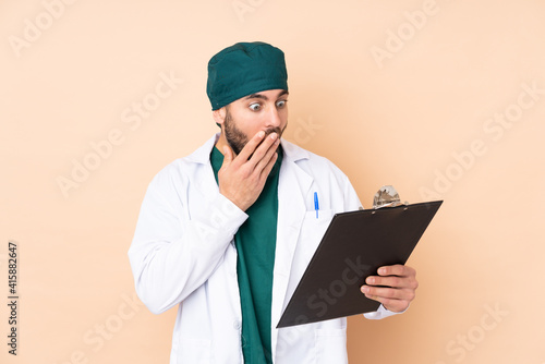 Surgeon in uniform isolated on beige background