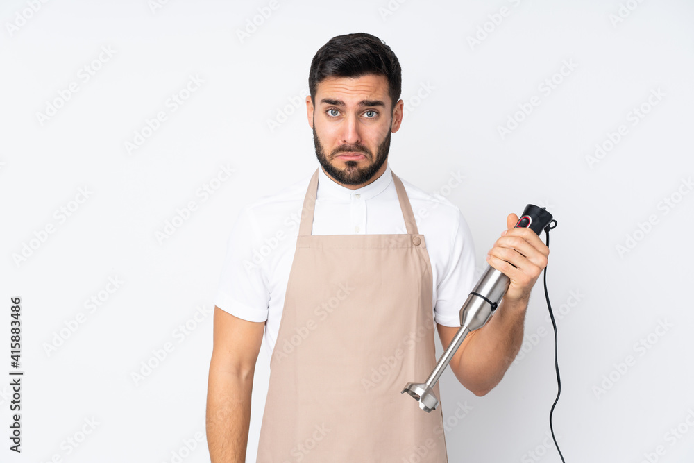 Man using hand blender isolated on white background sad