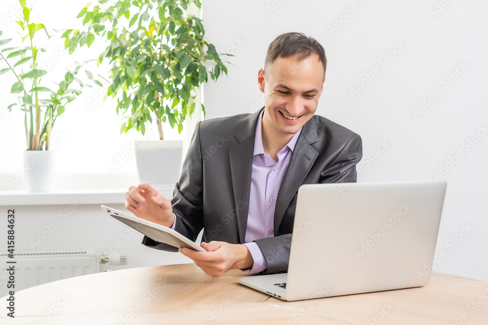 Handsome businessman working with laptop in office Handsome businessman working with laptop in office