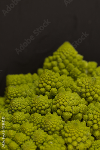 Fresh romanesco broccoli, on black background