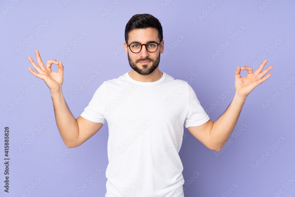 Caucasian handsome man over isolated background in zen pose Caucasian handsome man over isolated background in zen pose