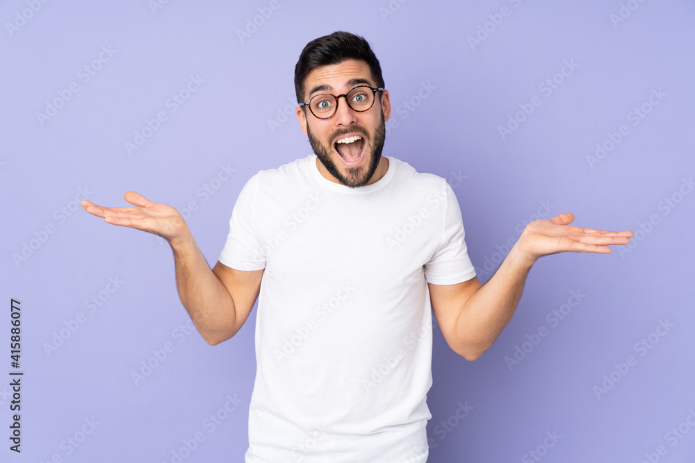 Caucasian handsome man over isolated background with shocked facial expression Caucasian handsome man over isolated background with shocked facial expression