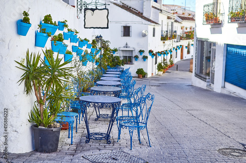 Picturesque street of Mijas with flower pots on facades. Andalusian white town. Cost of the Sun. Southern Spain