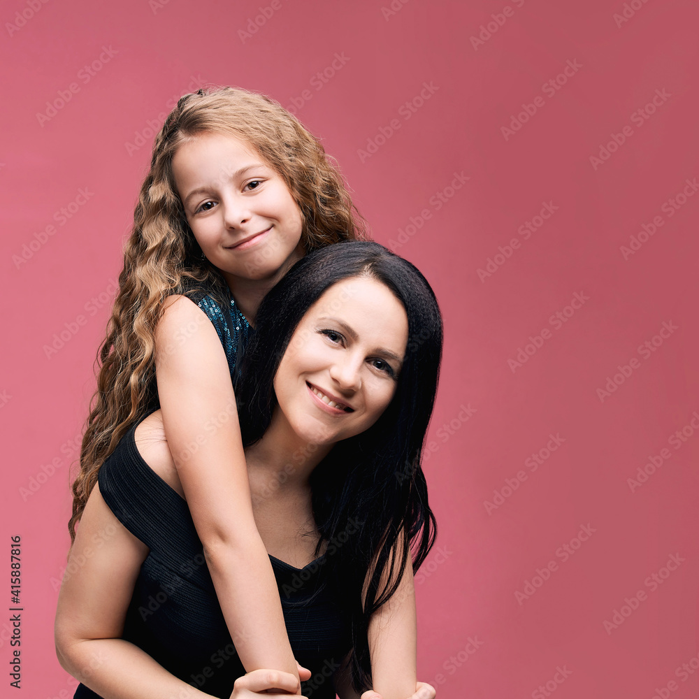 Mother and little daughter. Happy family portrait. Mom hug. Indoor studio lifestyle. Cute face. Smile positive parent. Female child love. Pink background. Baby girl. Casual cloth Mother and little daughter. Happy family portrait. Mom hug. Indoor studio lifestyle. Cute face. Smile positive parent. Female child love. Pink background. Baby girl. Casual cloth