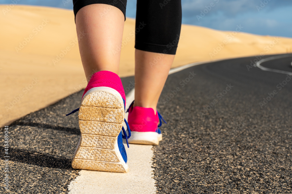 feet woman running on the road