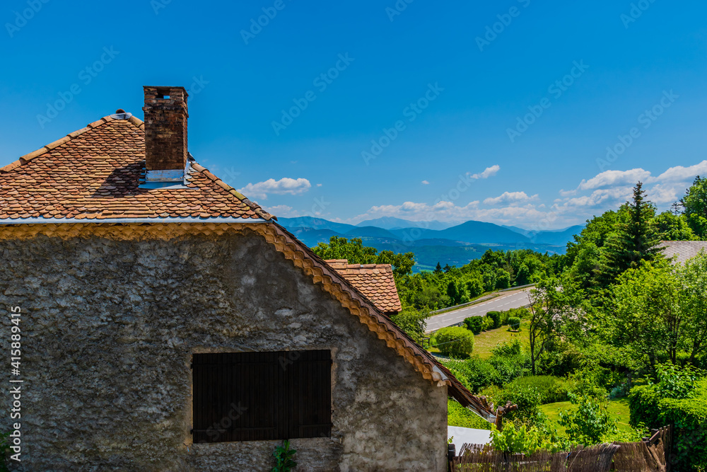 A close-up of an old stone house in a French alpine village in summer A close-up of an old stone house in a French alpine village in summer