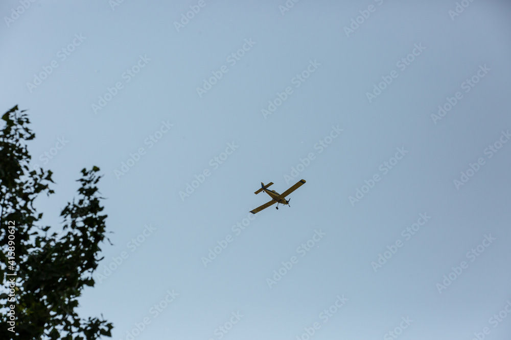 Small airplane silhouette against blue summer sky Small airplane silhouette against blue summer sky