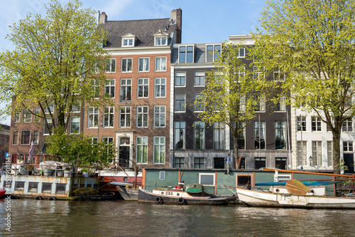 Europe, Netherlands, Amsterdam. Boats and houses along canal.