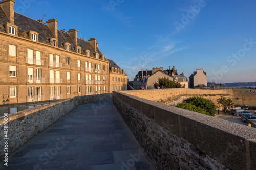 View at sunset from the wall of the old city with granite buildings of Saint-Malo in Brittany, France