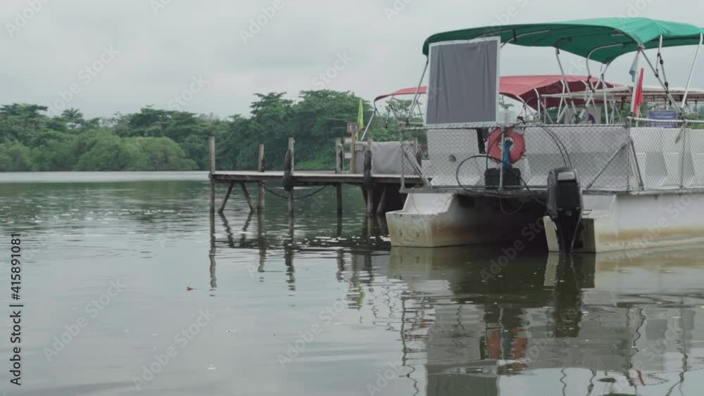 ferry and taxi boat in the marapendi lagoon, seen from the edge of a pier located on the reserve beach in rio de janeiro ferry and taxi boat in the marapendi lagoon, seen from the edge of a pier located on the reserve beach in rio de janeiro