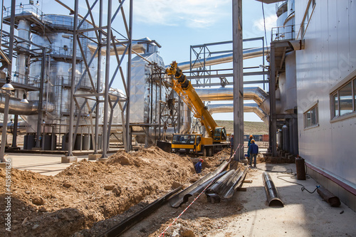 Sulfuric acid plant. Ground works for modernization and renovation with construction workers.