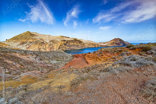 Rocks and multicolored ocher sands, blue sea at the eastern point of the island of Madeira and the point of saint lorenzo (Ponta de São Lourenço)