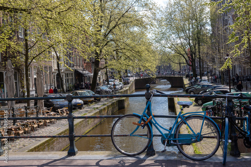 Europe, Netherlands, Amsterdam. Canal scene featuring blue bicycle.