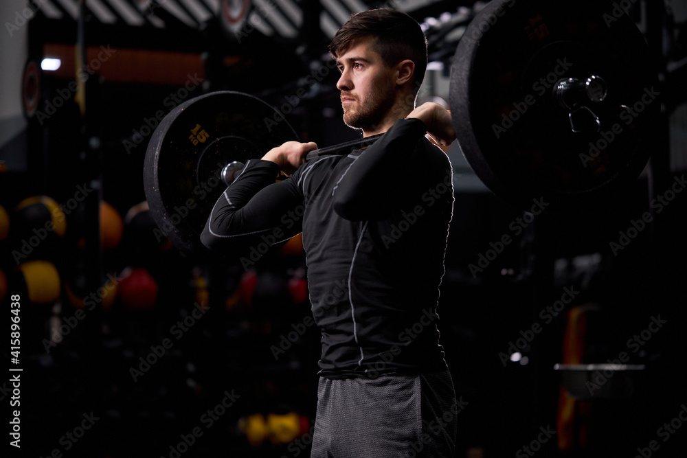 Fototapeta premium cross fit sportsman lifting barbell at gym. Man practicing functional training powerlifting workout exercises alone, in sportswear. weightlifting, bodybuilding concept