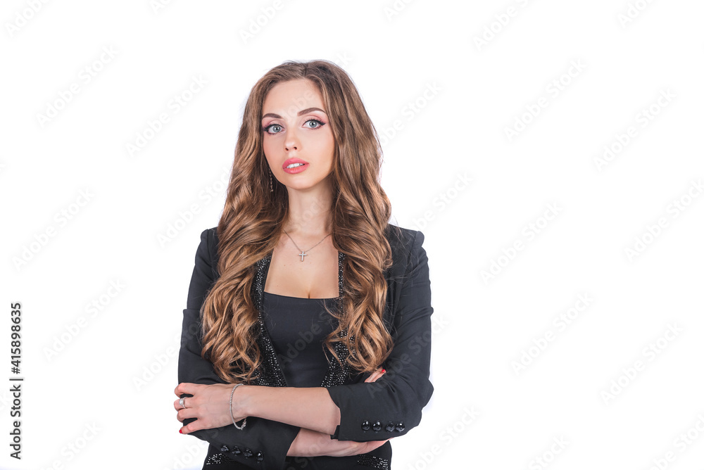 A beautiful woman in a black business suit with a make-up and long hair stands on a white isolated background in the studio. Working and business woman concept A beautiful woman in a black business suit with a make-up and long hair stands on a white isolated background in the studio. Working and business woman concept