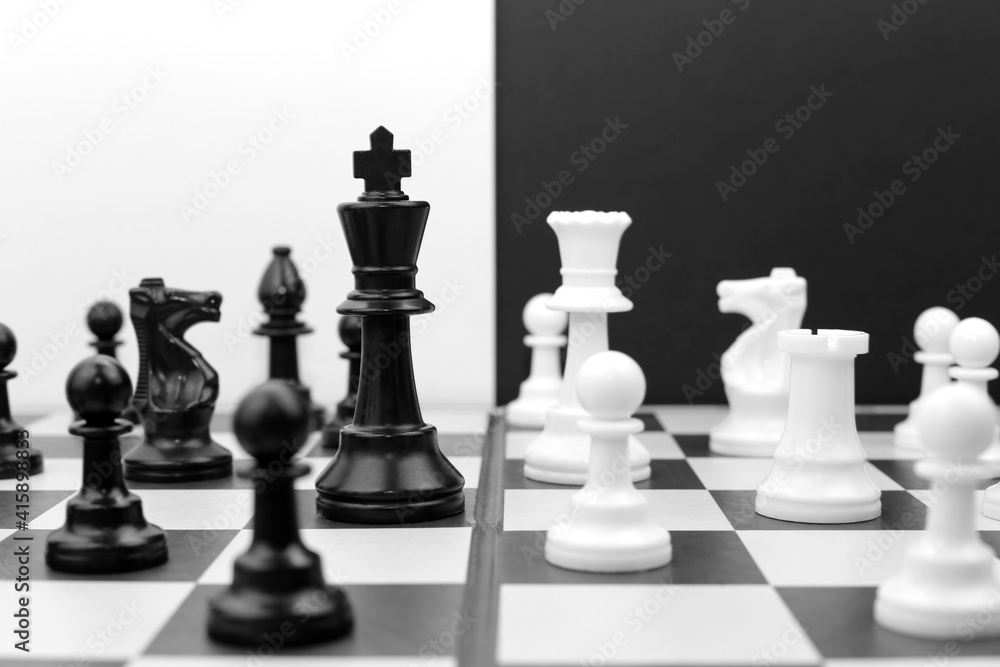 Black and white chess pieces on the board. Chess game.
Black and white chess pieces on the board. Chess game.