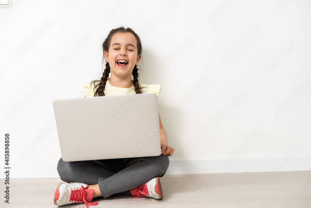 Little funny girl with laptop on white background Little funny girl with laptop on white background