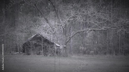 spooky vintage black and white video scene of a back water abandoned swamp building