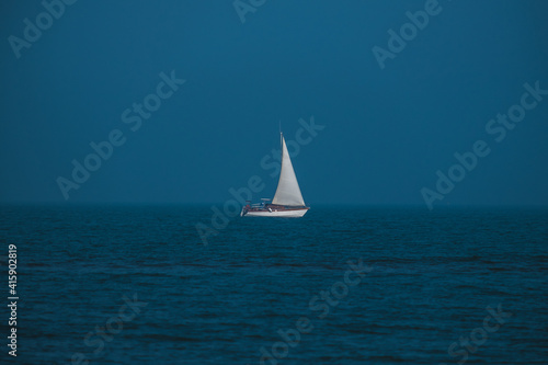 Isolated sailboat in the middle of the sea © Marco Bonomo