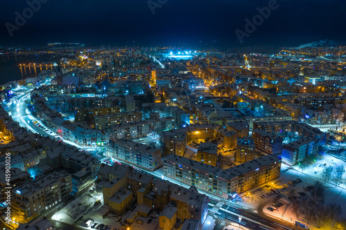 Elk city covered with snow. Night urban landscape. Aerial view. © ysuel