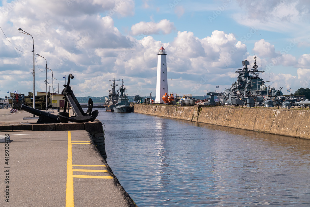 Russia. Kronstadt. July 3, 2020. The western mooring wall of the Petrovsky dock of the sluice canal and the lighthouse on it.