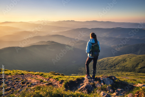 Girl on mountain peak with ...