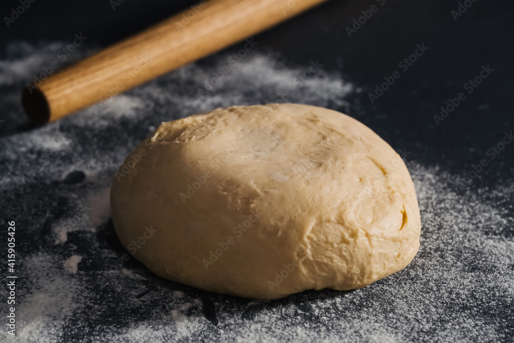 Handmade dough for bread on dark table background Handmade dough for bread on dark table background