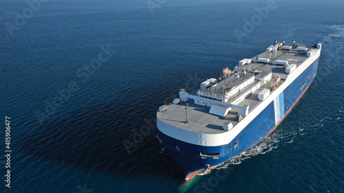 Aerial drone photo of huge car carrier ship RO-RO (Roll on Roll off) cruising in Mediterranean deep blue Aegean sea © aerial-drone