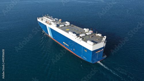 Aerial drone photo of huge car carrier ship RO-RO (Roll on Roll off) cruising in Mediterranean deep blue Aegean sea
