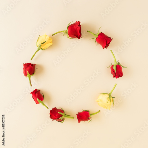 Circle shape copy space with red an yellow flowers. Woman's day background design. Minimal flat lay nature.