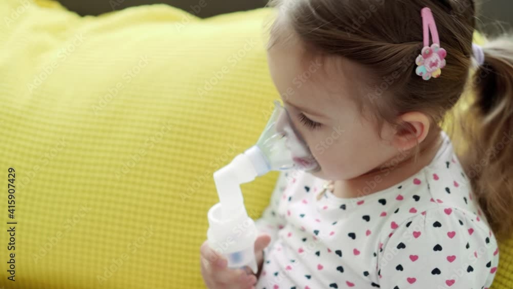 Baby Using Inhaler close up Caucasian 3-4 years minor preschool girl kid in the mask of an ...