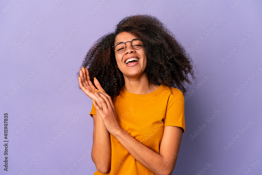 Young african american curly woman isolated on purple background feeling energetic and comfortable, rubbing hands confident. Young african american curly woman isolated on purple background feeling energetic and comfortable, rubbing hands confident.