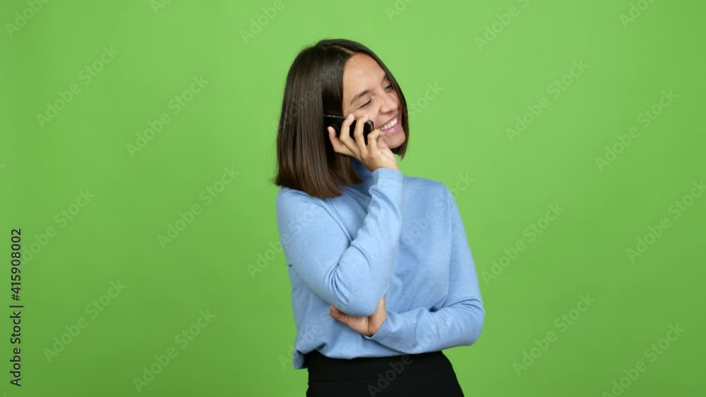 Young brunette woman using mobile phone over isolated background Young brunette woman using mobile phone over isolated background