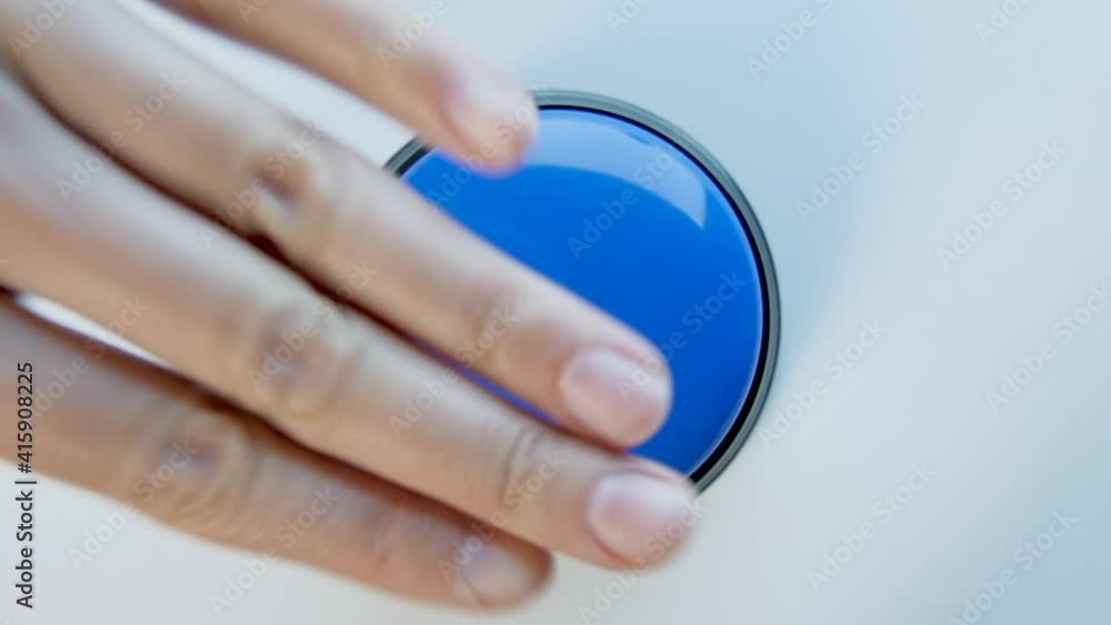 Young woman pushing blue button with a finger and palm of her hand. Press a round glossy button close up. Activation, launching something. Turn on and off. Young woman pushing blue button with a finger and palm of her hand. Press a round glossy button close up. Activation, launching something. Turn on and off.
