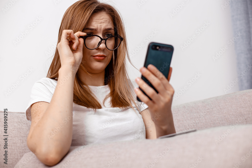 Happy girl sit living room couch speak phone relax. Excited young woman reading unexpected good message. Photo of funny young girl sit couch open mouth hold telephone talk. Happy girl sit living room couch speak phone relax. Excited young woman reading unexpected good message. Photo of funny young girl sit couch open mouth hold telephone talk.