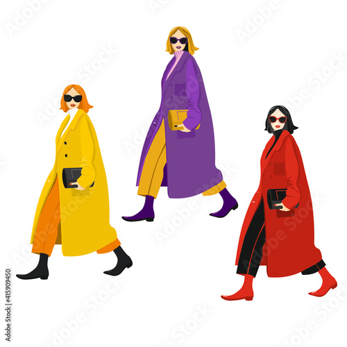 Young fashion girls in a coat with a handbag