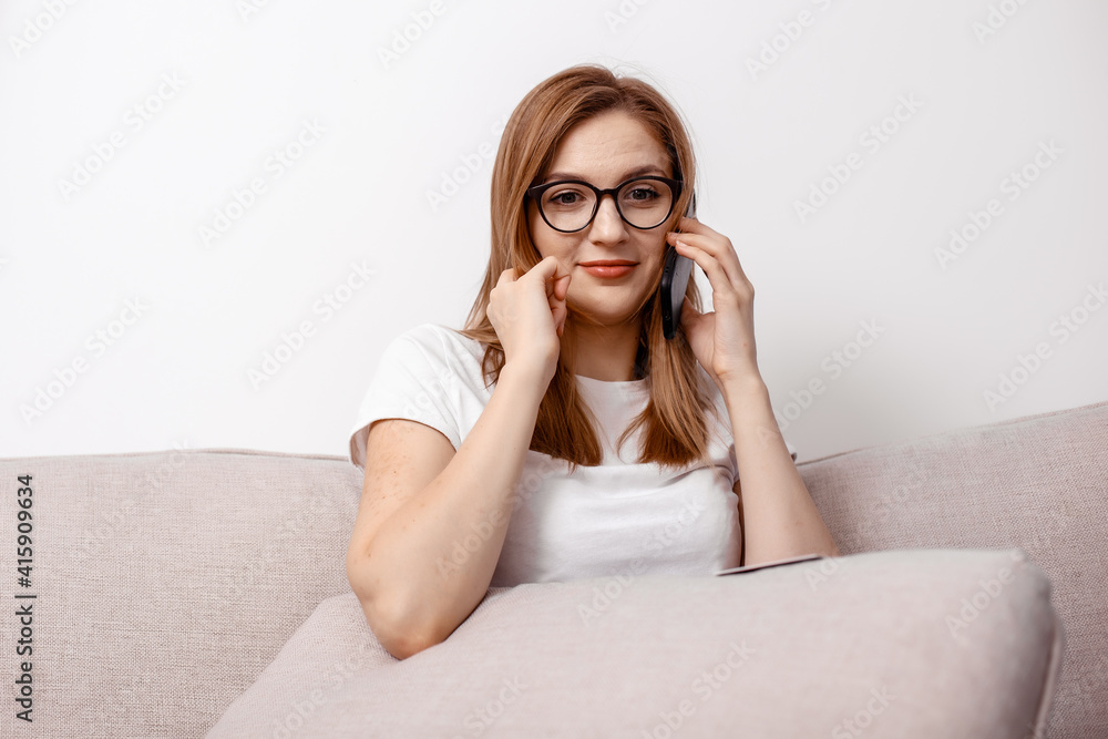 Happy girl sit living room couch speak phone relax. Excited young woman reading unexpected good message. Photo of funny young girl sit couch open mouth hold telephone talk. Happy girl sit living room couch speak phone relax. Excited young woman reading unexpected good message. Photo of funny young girl sit couch open mouth hold telephone talk.
