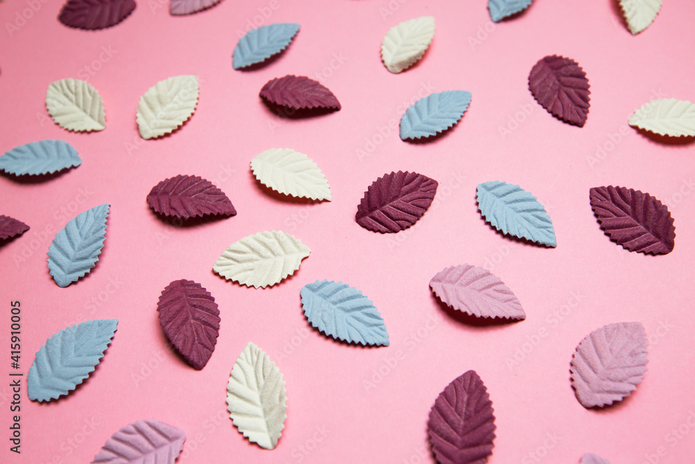 multicolored paper petals on pink background multicolored paper petals on pink background