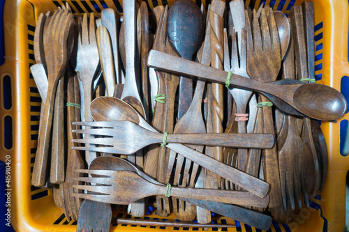 Wooden spoon and fork for sale isolated in a basket