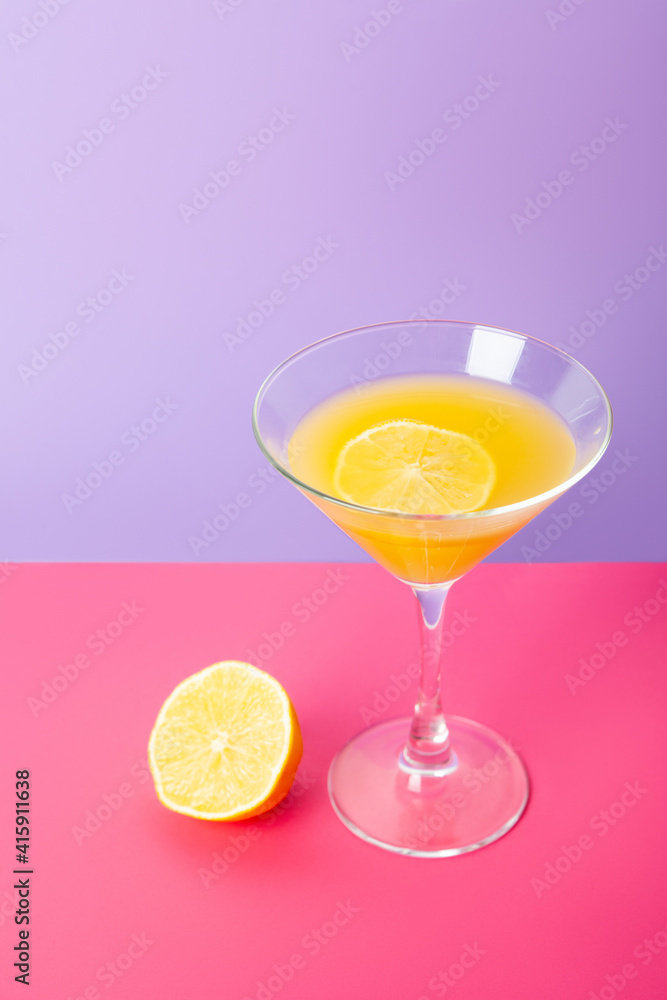 Refreshing yellow lemon cocktail in glass on table Refreshing yellow lemon cocktail in glass on table