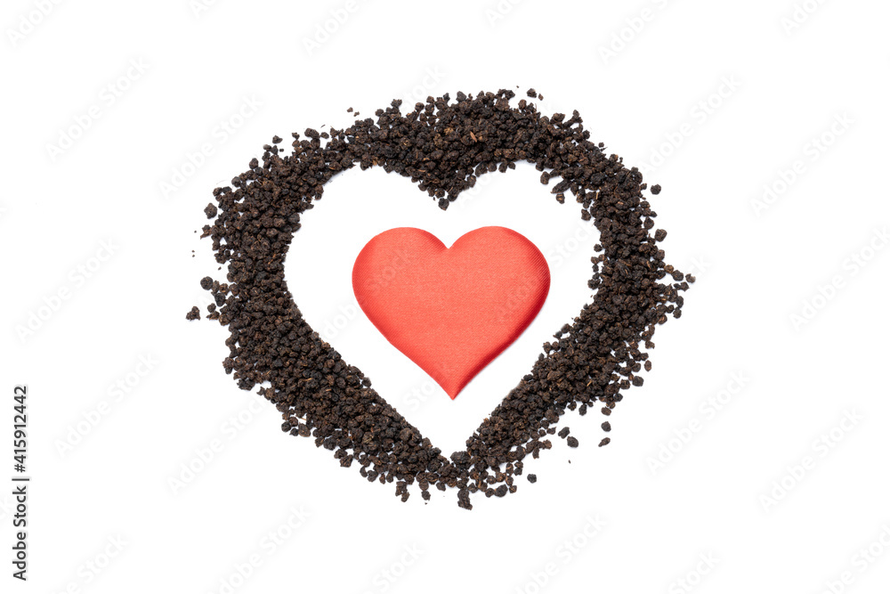 black tea granules isolated on white background. design element. heart symbol made by dry tea heap cut out