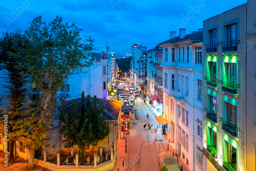 Photography Night view from a upper level window overlooking a busy street in Istanbul, Turkey, with the Bosphorus Bridge and Ortaköy Mosque illuminated
