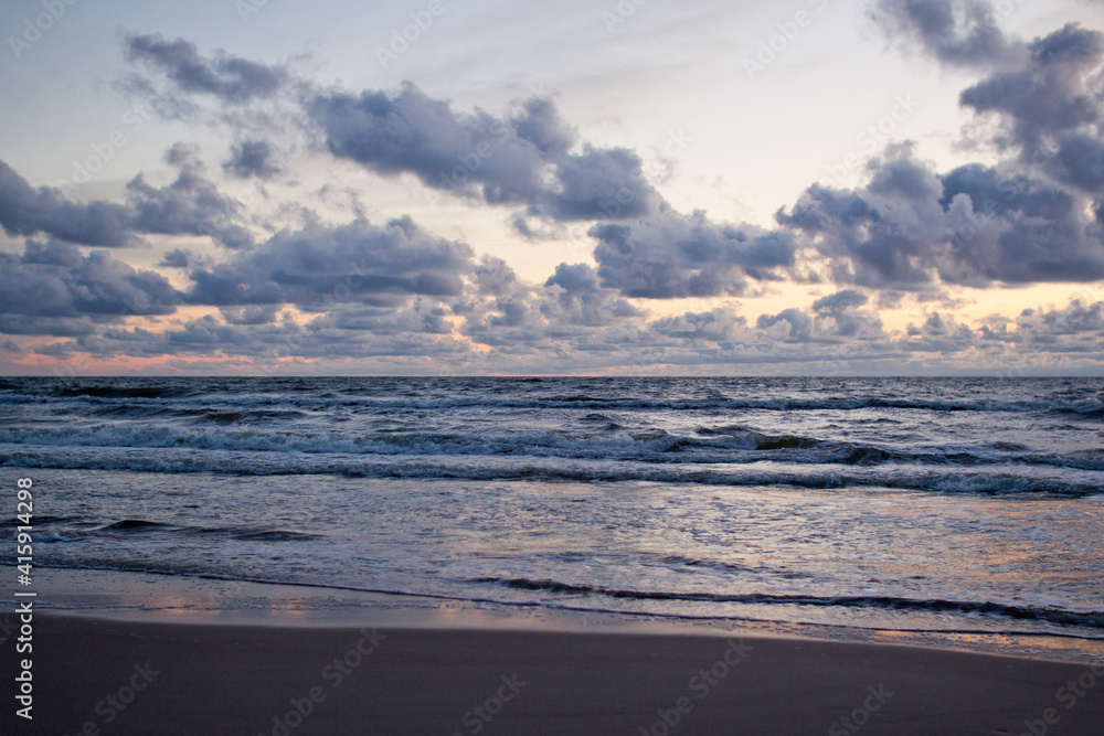 Evening seascape with clouds and waves.