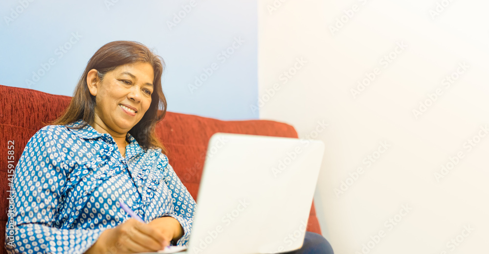 Working from home.Online learning.Senior indian woman video call to her friend.working on laptop.Call video meeting during Coronavirus Covid19.Lockdown Stay at home, quarantine.learning, shopping. Working from home.Online learning.Senior indian woman video call to her friend.working on laptop.Call video meeting during Coronavirus Covid19.Lockdown Stay at home, quarantine.learning, shopping.