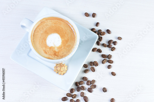 Cup of colombian coffee, decorated on white wooden background © KreaFoto