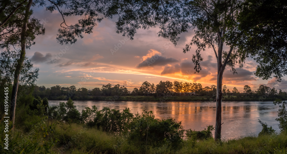 Beautiful Panoramic Riverside Sunset with Dramatic Sky and Reflections