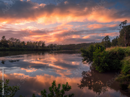 Riverside Sunrise with Beautiful Cloud Reflections