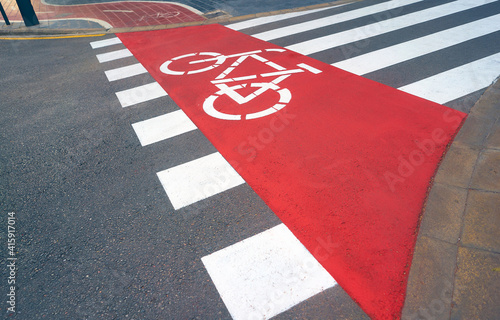 Road with freshly painted zebra crossing and bicycle lane