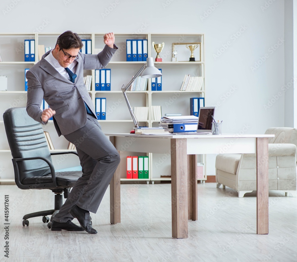 Businessman having fun taking a break in the office at work Businessman having fun taking a break in the office at work