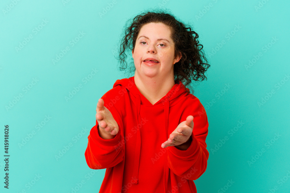 Woman with Down syndrome isolated feels confident giving a hug to the camera. Woman with Down syndrome isolated feels confident giving a hug to the camera.